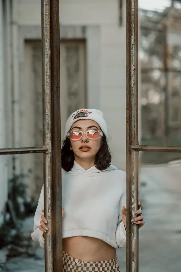 Trendy Woman Posing Behind Metal Bars Wearing a White Top