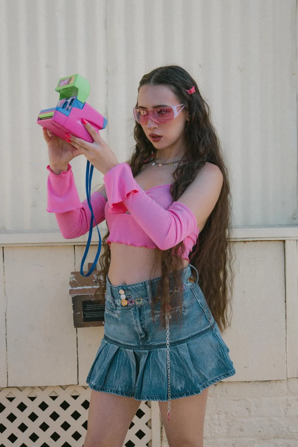 Trendy Young Woman Wearing Pink Gloves and a Denim Skirt