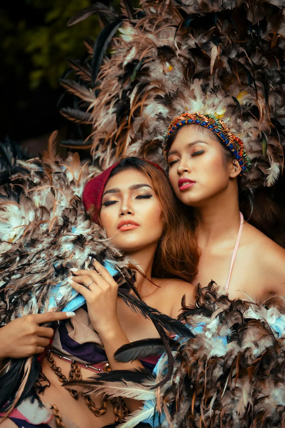Two Women in Feather Outfits Posing Together Free Wallpaper