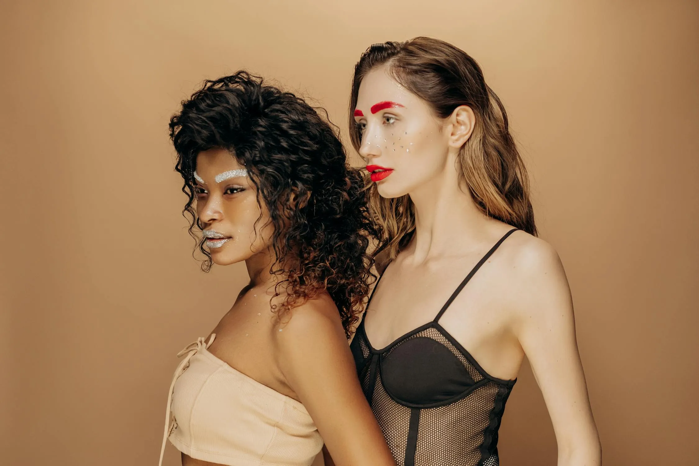 Two Women Standing Close in a Dramatic Beauty Portrait Image