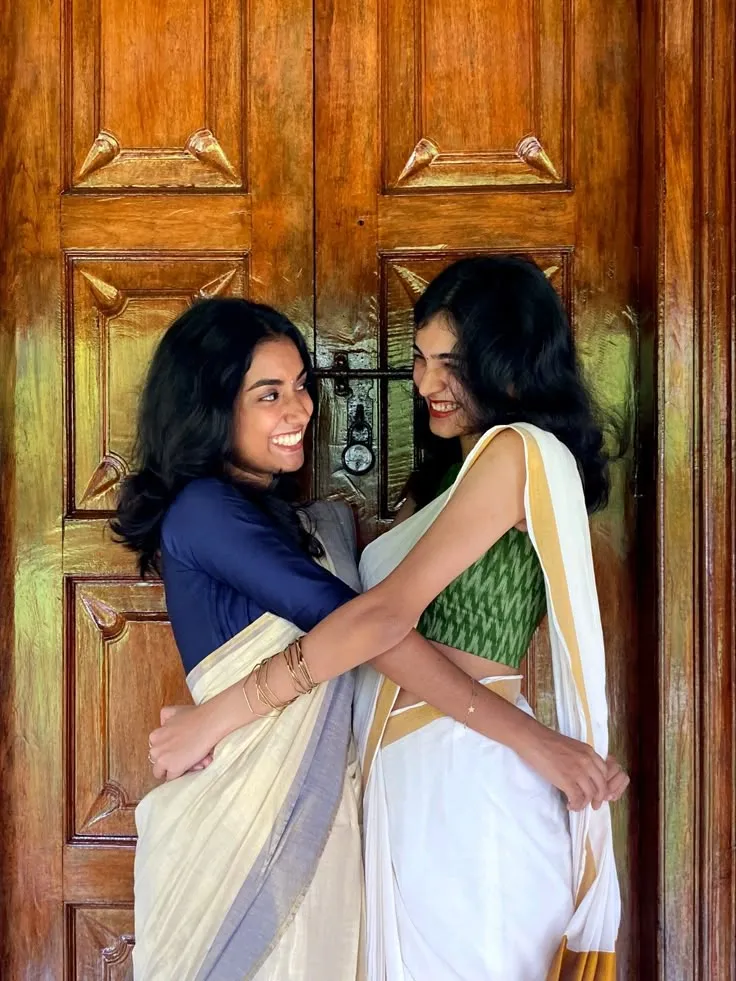 Two young girls in a traditional Kerala white saree image