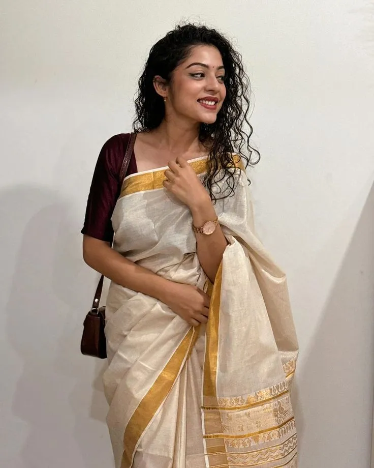 Varsha Bollamma in a white dress with a meroon blouse image