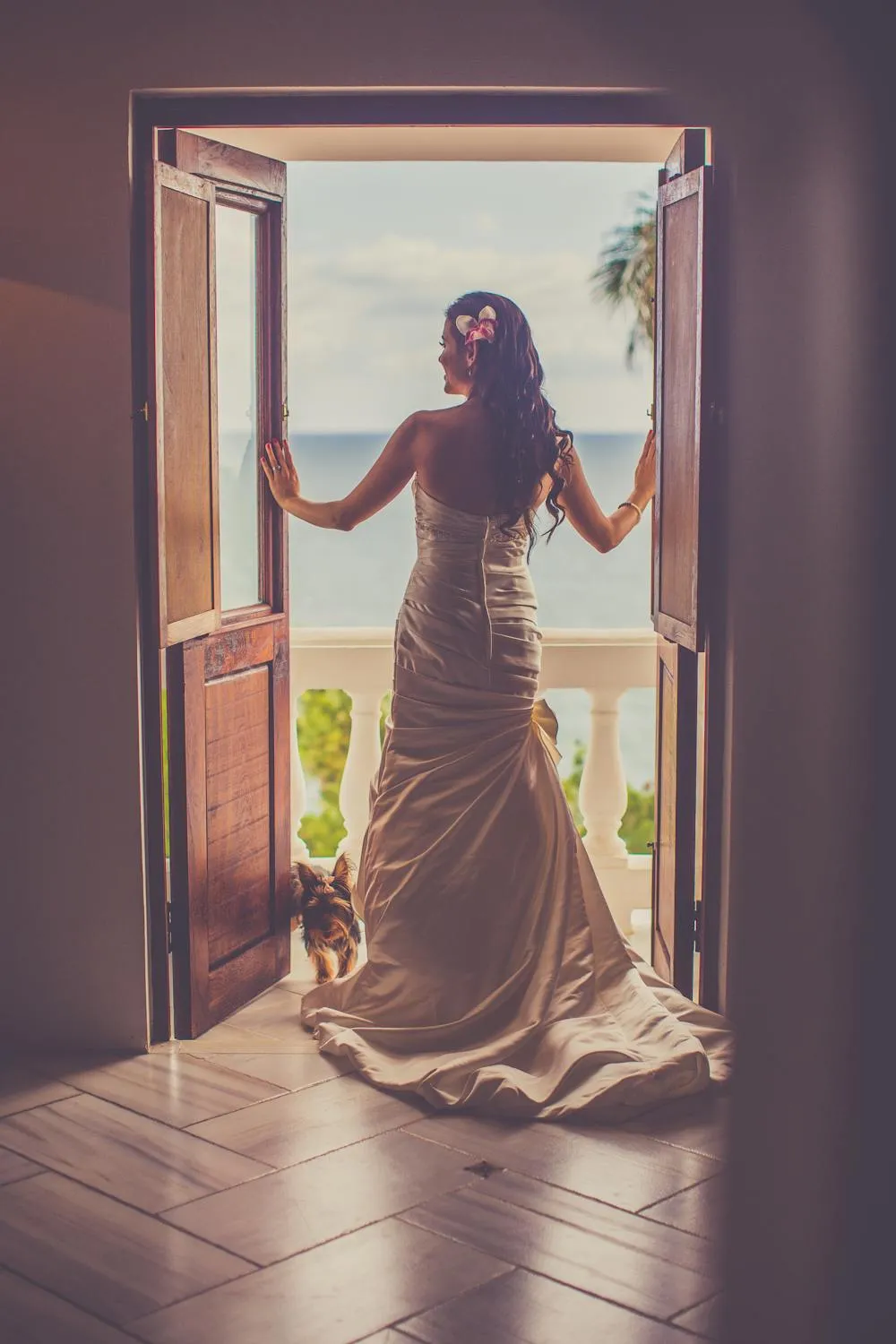 Woman in an Elegant Gown Standing At a Balcony Doorway Image