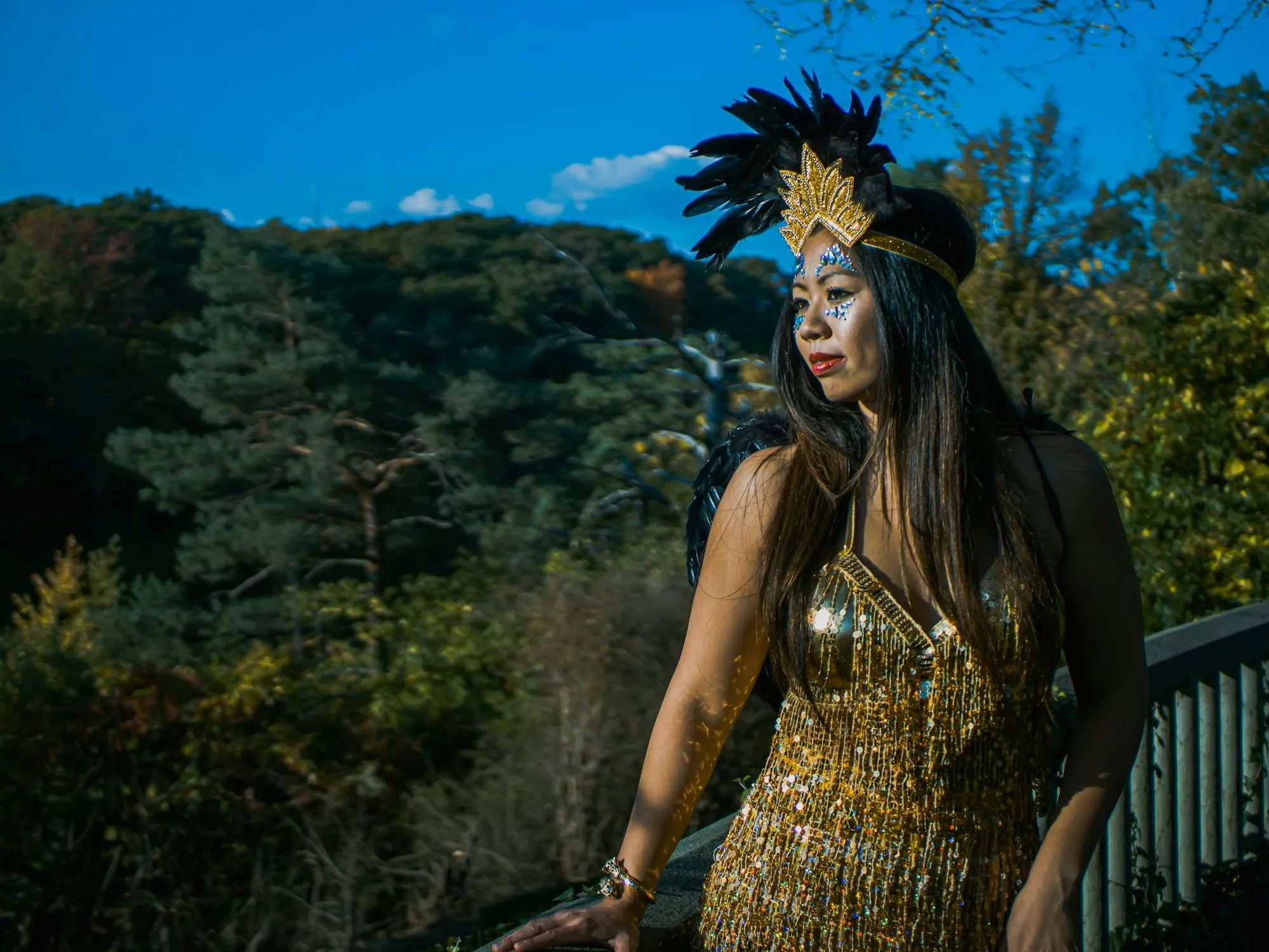 Woman in an Exotic Outfit Posing Outdoors with Mountains