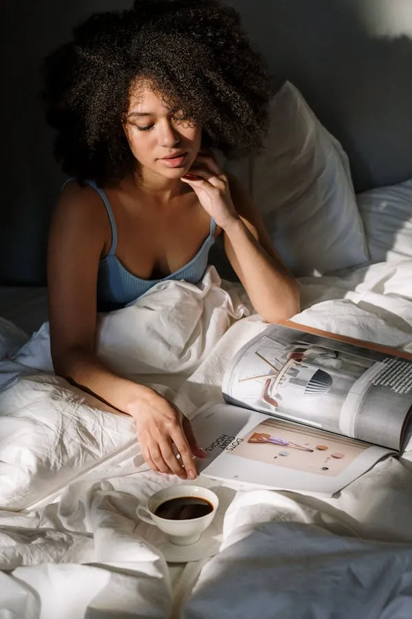 Woman in Bed with Coffee Looking Relaxed and Contemplative
