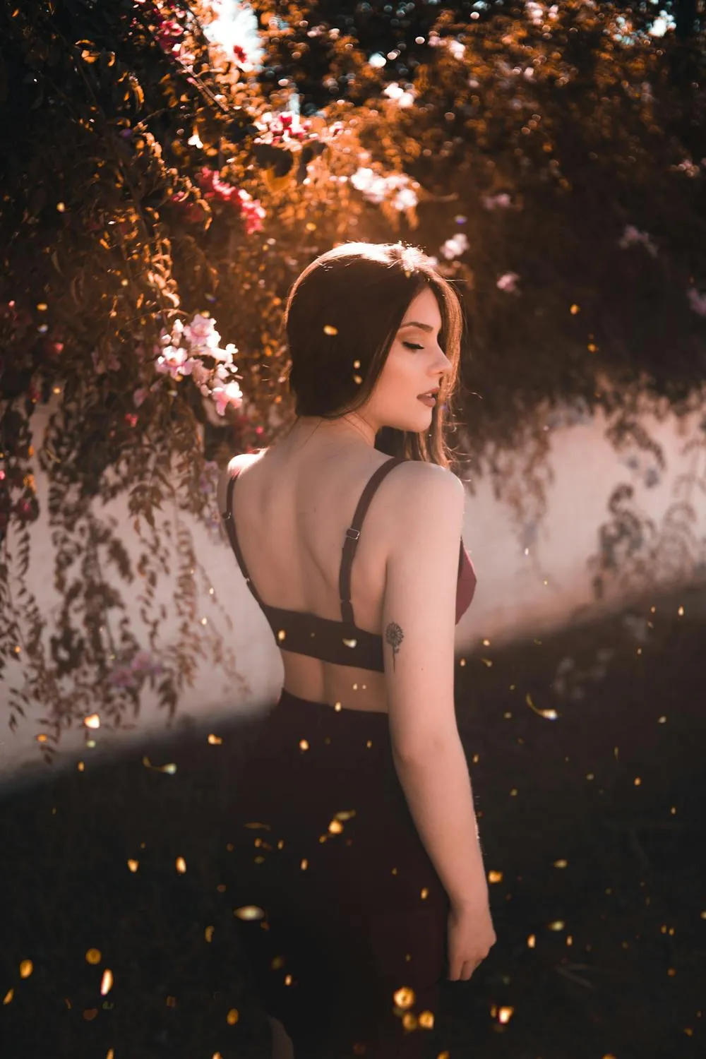 Woman in Black Dress Looking Back with Sunlight Wallpaper