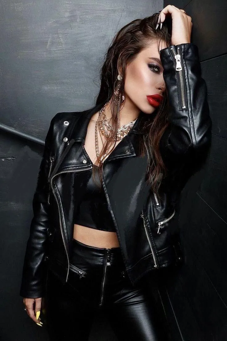Woman in a Black Leather Outfit Posing Confidently Indoors