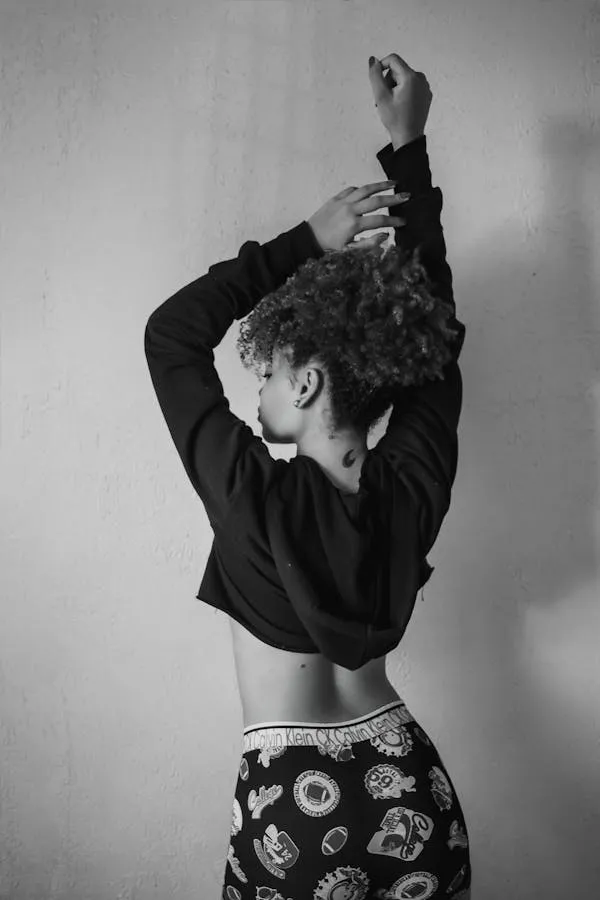 Woman in a Black Outfit with Hands on Head Free Wallpaper