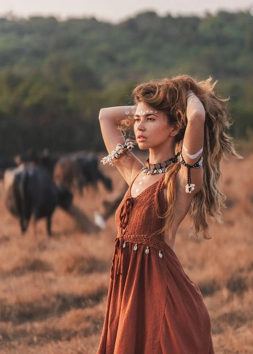 Woman in Black Top and White Jeans Smiling by the Building