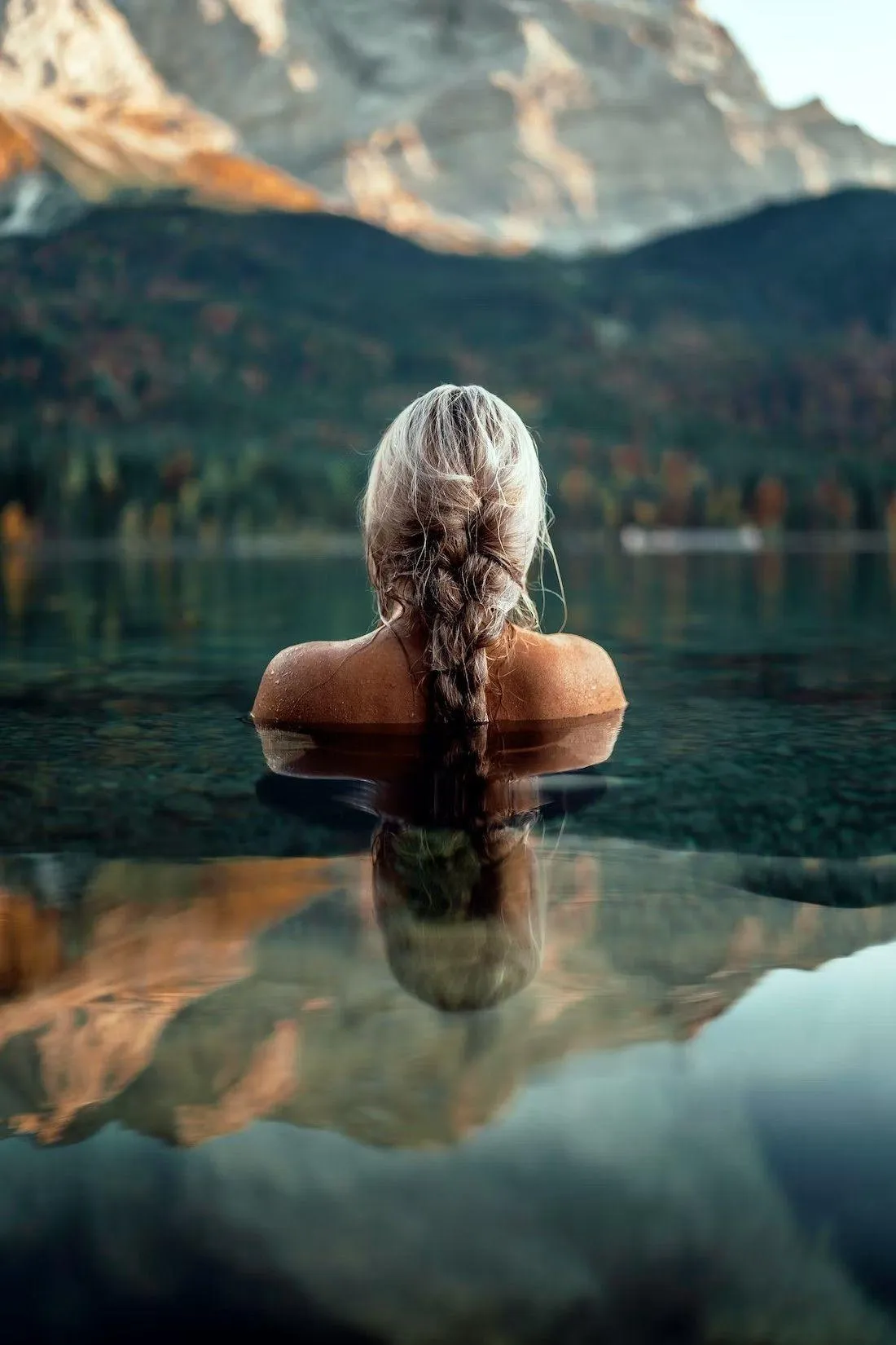 Woman with a Blonde Hair Floating in a Clear Mountain Lake