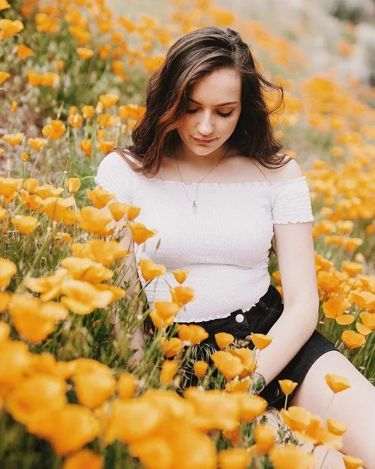 Woman in Blue Dress Walking Through a Colorful Flower Field