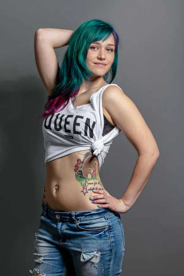 Woman with Blue Green Hair and Tattoos Wearing a White Top