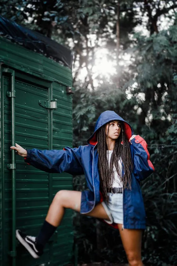Woman in Blue Hoodie Posing Near Green Outdoor in the Forest