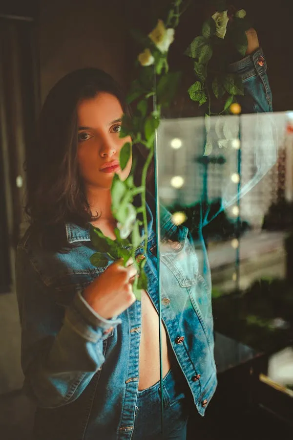 Woman in a Blue Scarf Looking Out of a Window Thoughtfully