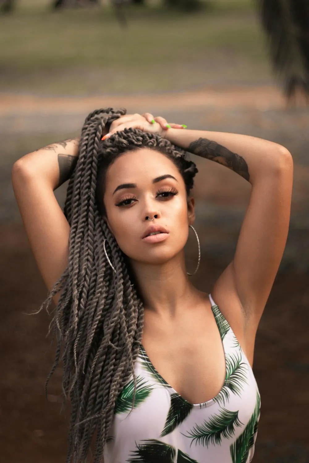 Woman with Braided Hair in Tropical Print Posing Outdoors