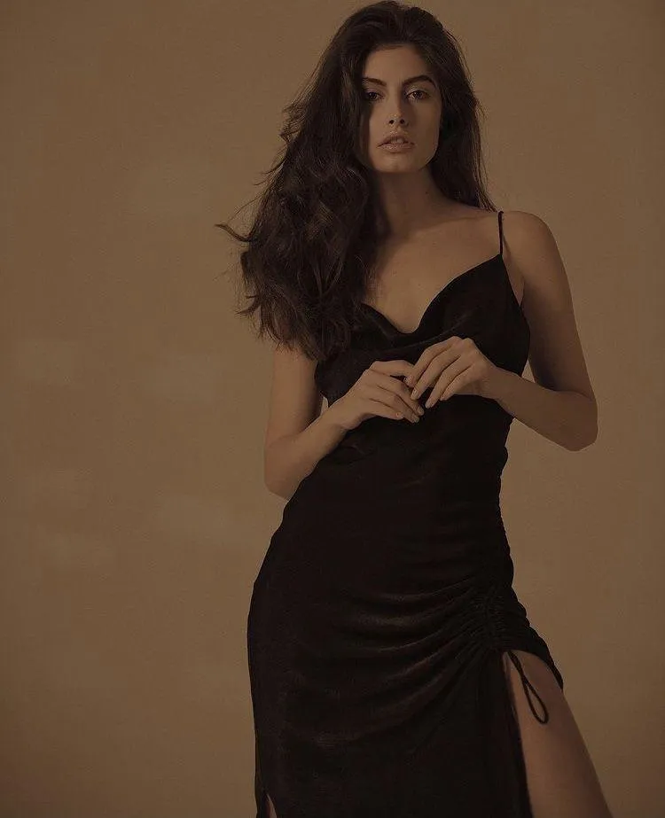 Woman in a Brown Satin Dress Posing with a Soft Expression