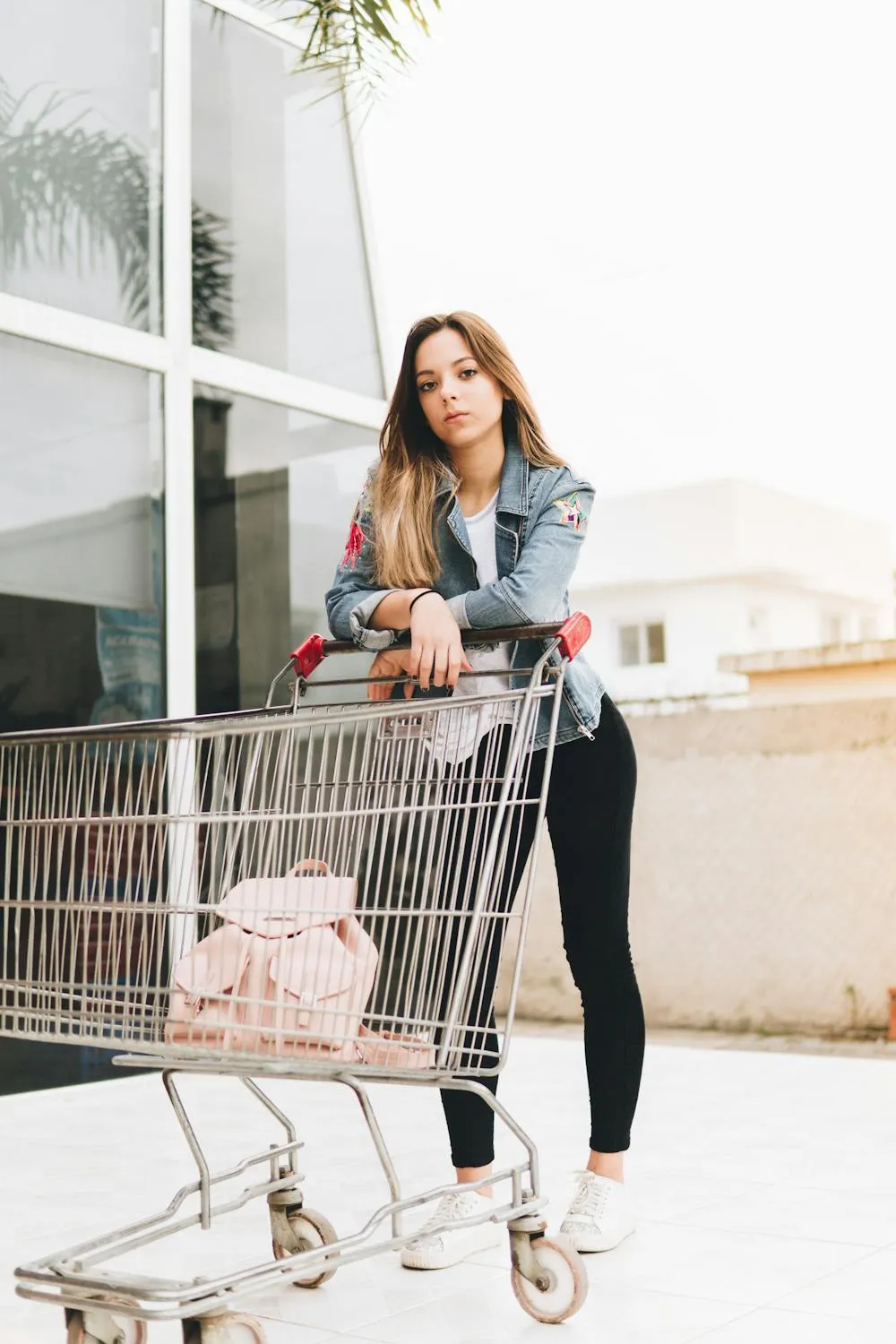 Woman Casually Leaning on a Shopping Cart Hd Free Wallpaper