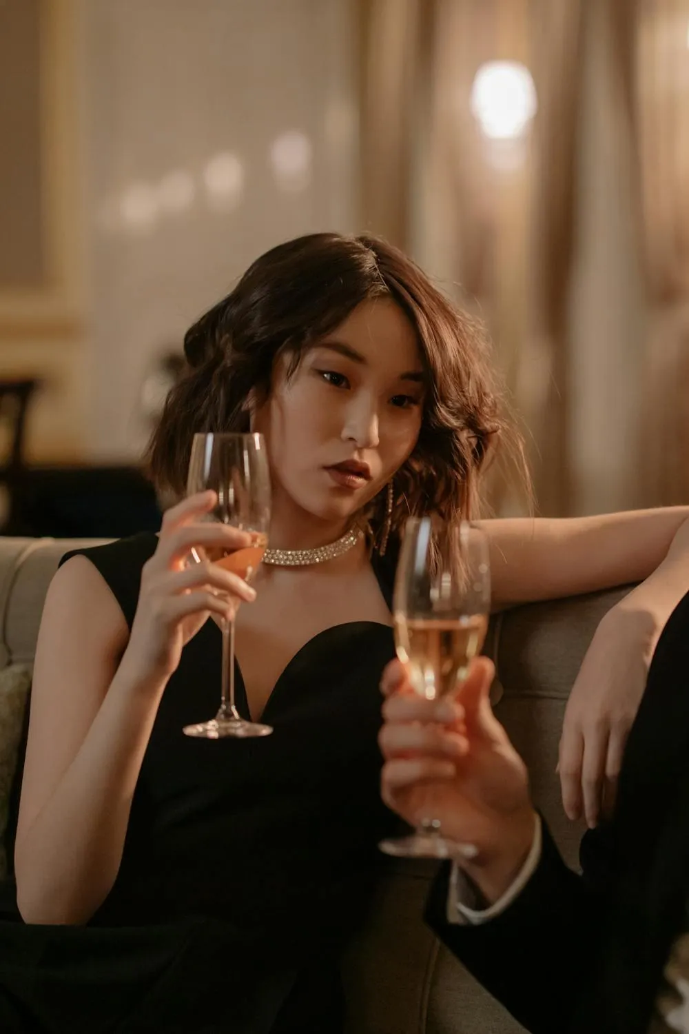 Woman with a Champagne Glass in an Elegant Evening Setting