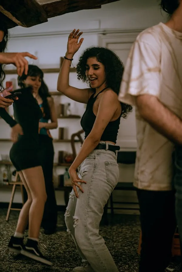 Woman Dancing Outdoors At Event with Joyful Energy Wallpaper