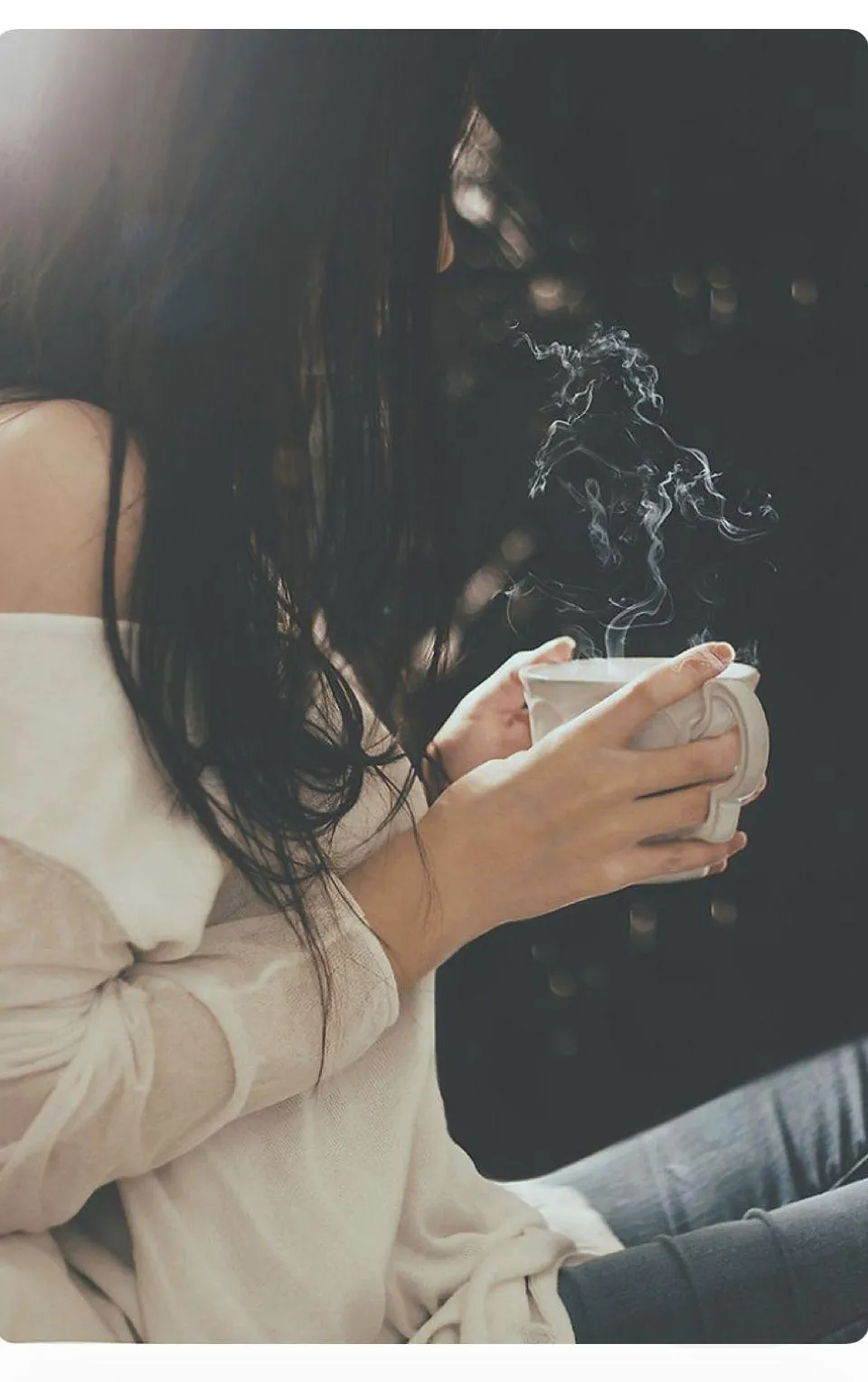 Woman with a Dark Hair Holding a Steaming Cup of Coffee