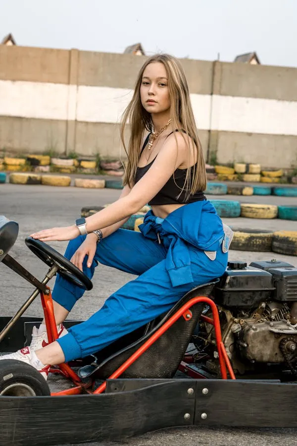 Woman in a Denim Outfit Sitting on the Ground with Sneakers
