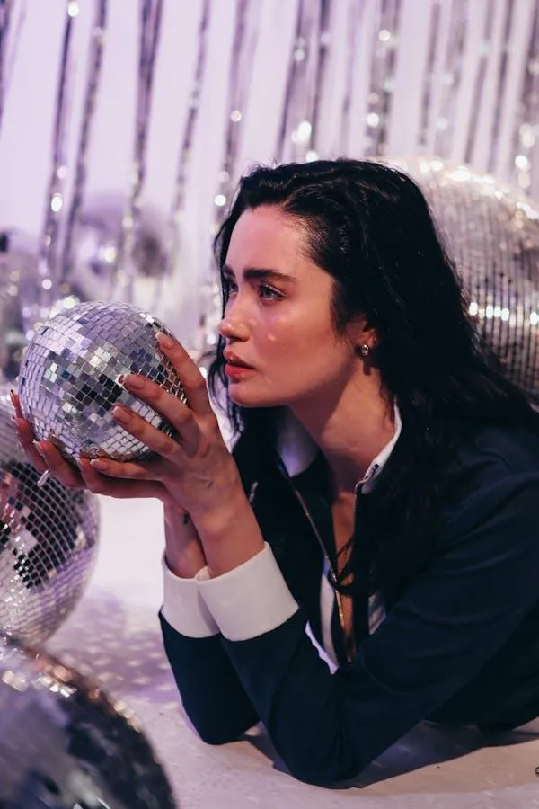 Woman with a Disco Ball Posing in a Glittery Party Setting
