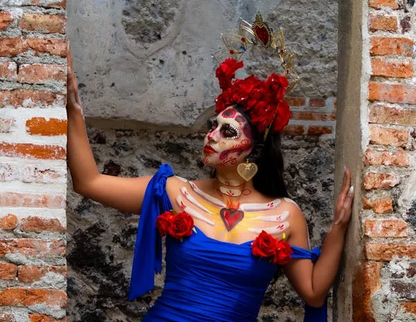 Woman Dressed in a Vibrant Day of the Dead Costume Wallpaper