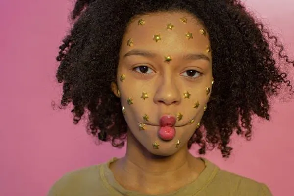 Woman with Face Mask Posing in Front of a Pink Background