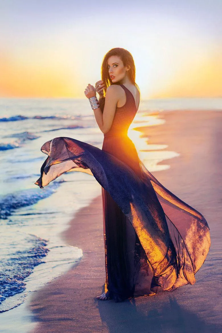 Woman Facing Away in the Field with Her Hand in Her Hair