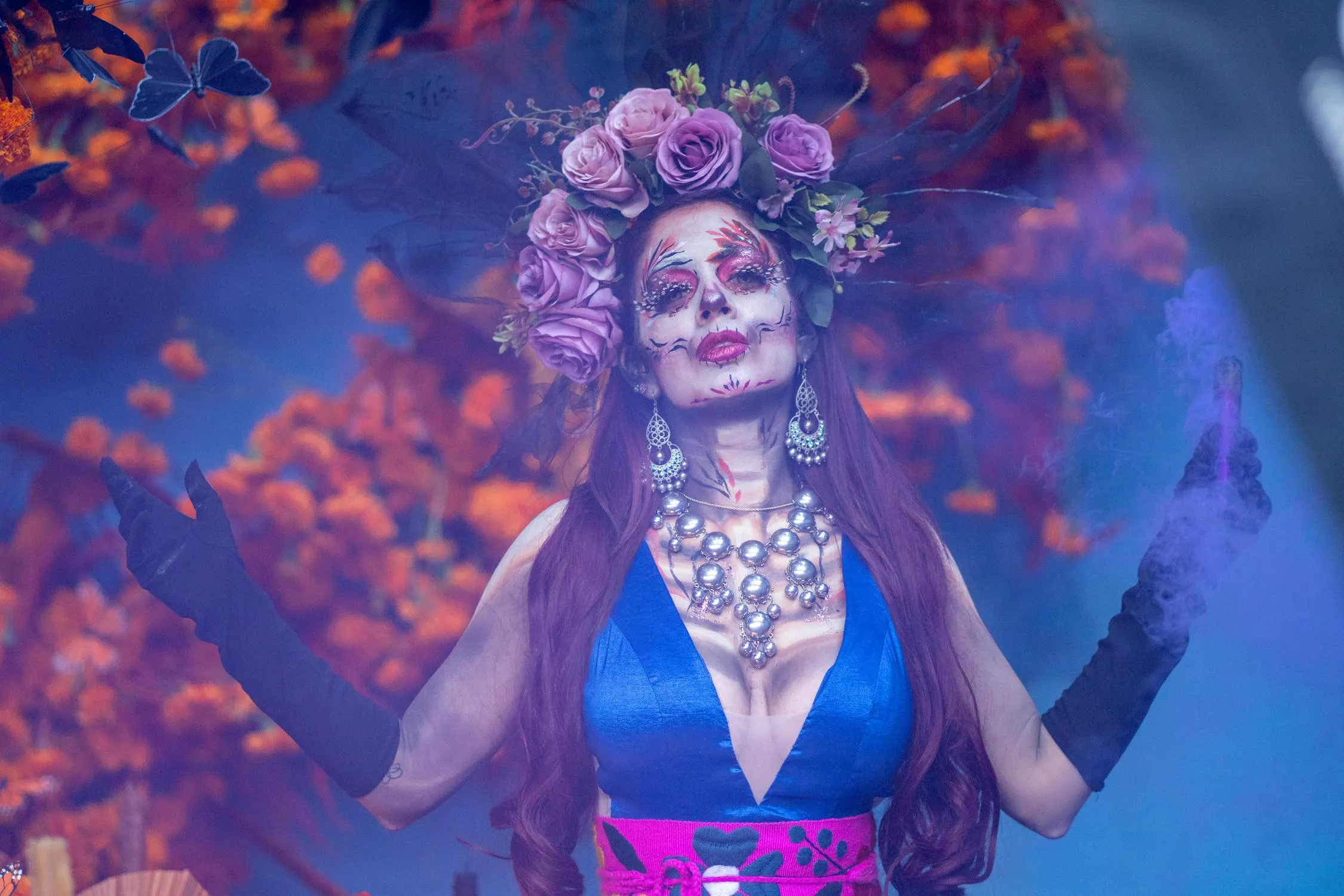 Woman in Floral Crown with Face Paint in a Garden Scene