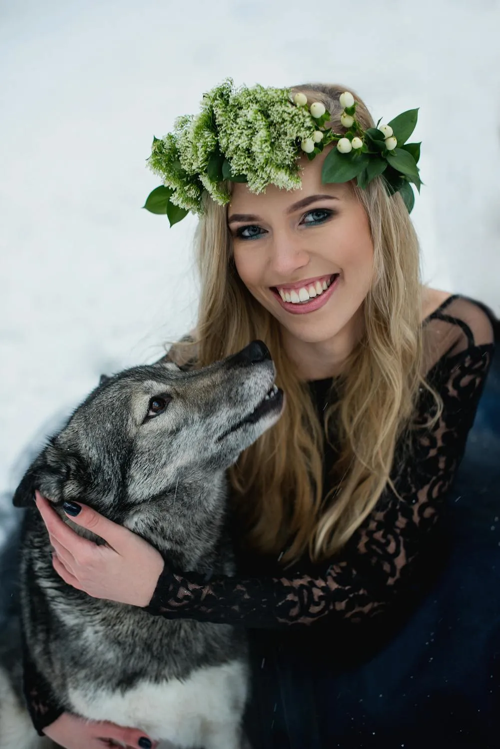 Woman with Flower Crown Holding a Happy Husky Dog Wallpaper