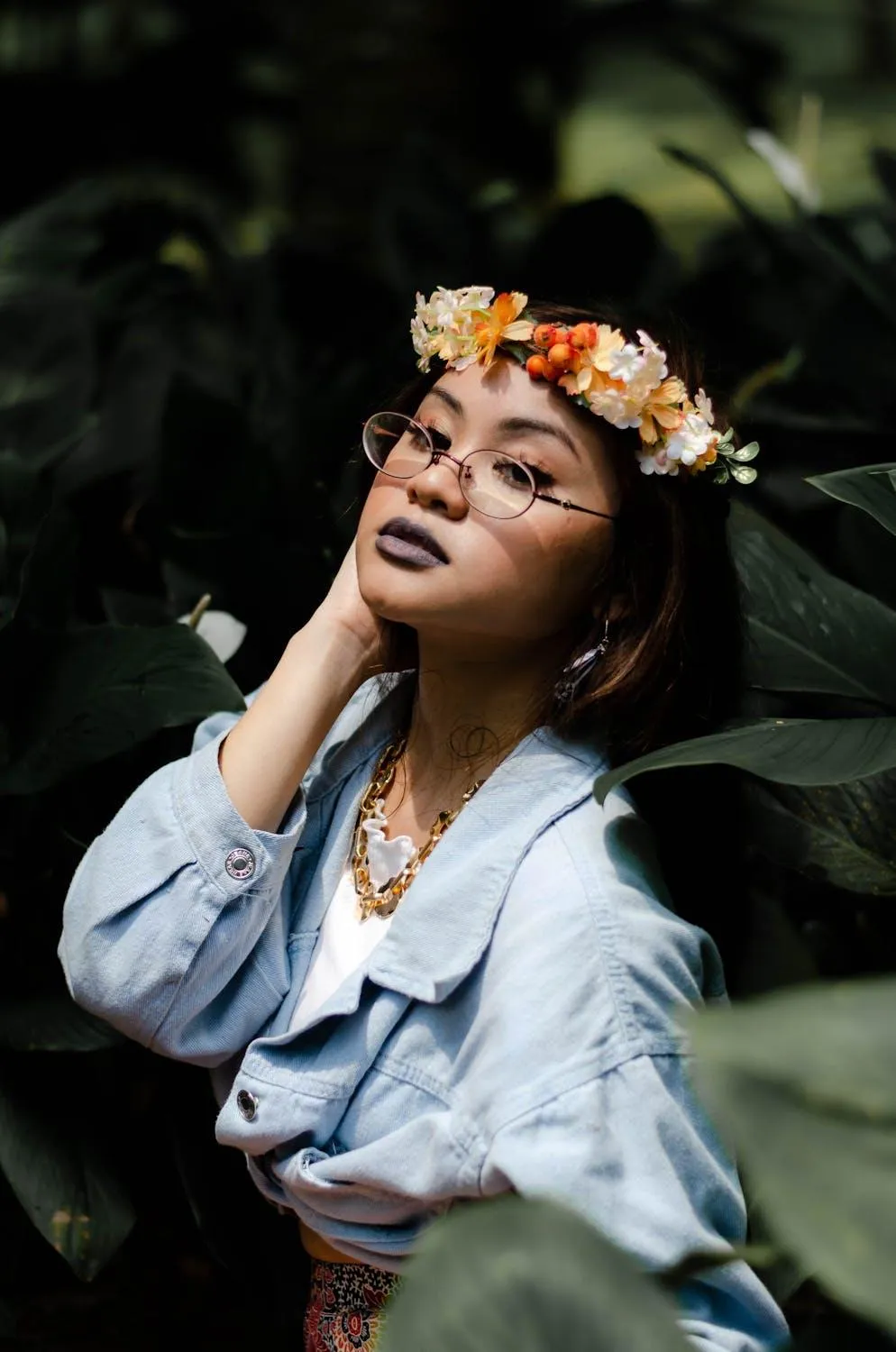 Woman with a Flower Crown Posing Joyfully in Natural Setting