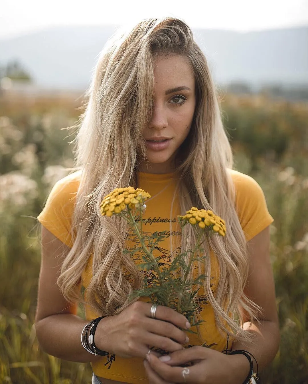 Woman in a Flower Crown Smiling Gently in Natural Sunlight