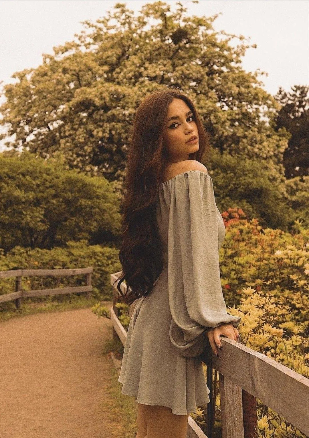 Woman in a Flowing Dress Standing on Path with Trees Around