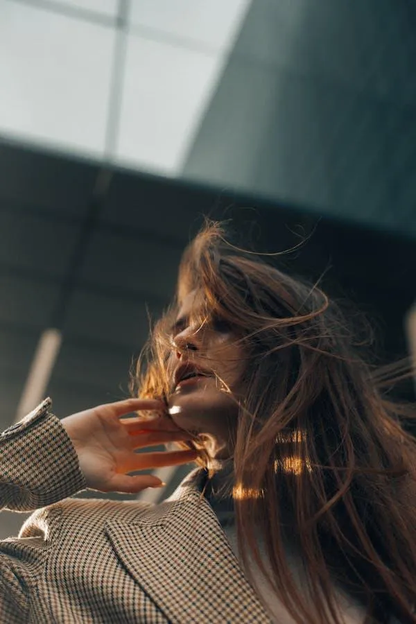 Woman with a Flowing Hair Posing Against a Modern Building