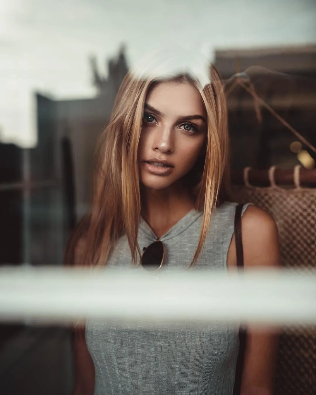 Woman Gazing Through a Window in Soft Indoor Lighting Image