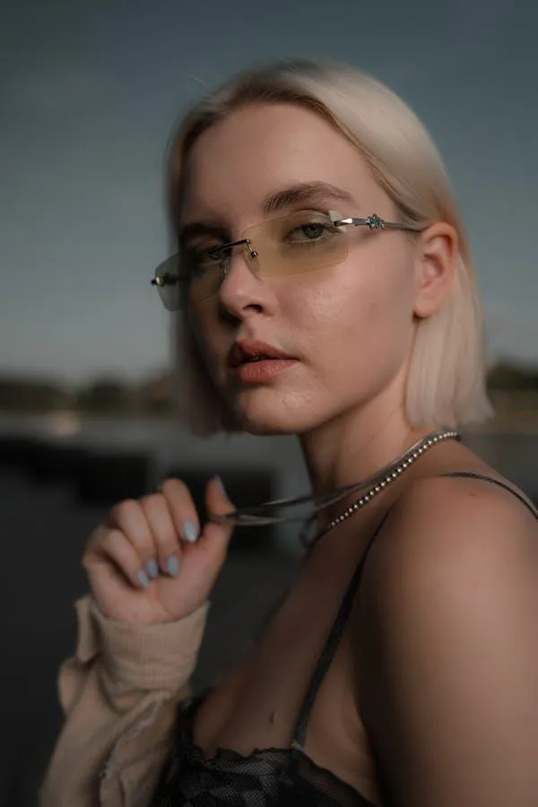Woman with Glasses Posing Thoughtfully During Golden Hour