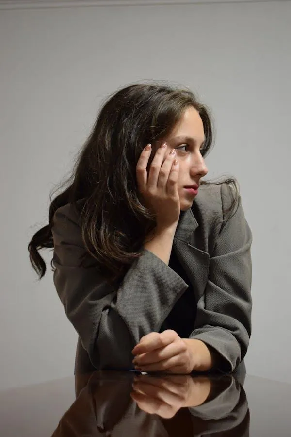 Woman in a Gray Suit Sitting and Gazing Off To the Side