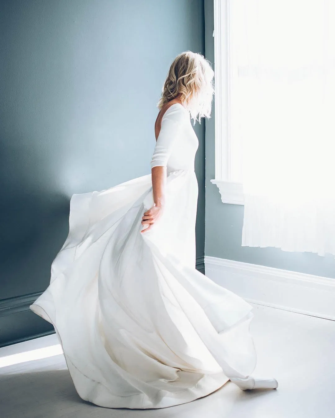 Woman in a Gray Top Sitting in a Dark Moody Soft Lighting