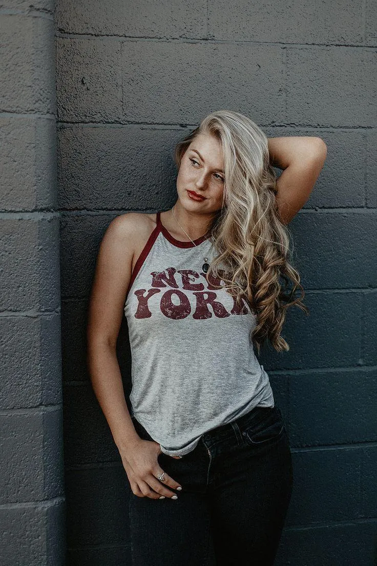 Woman Holding a Camera with Flower in Her Hair At the Beach