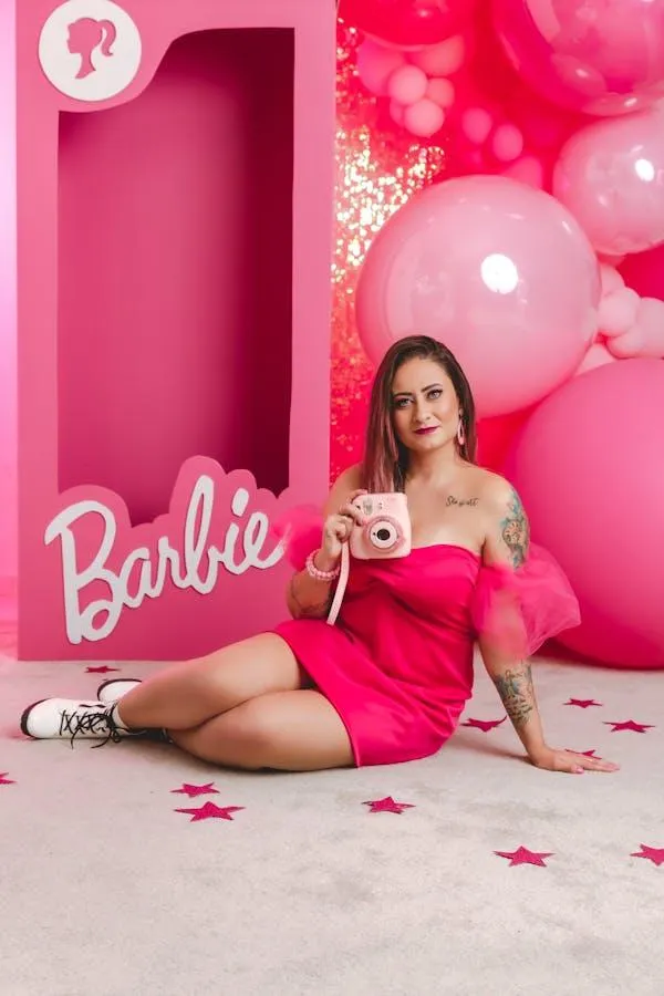 Woman in a Hot Pink Dress Sitting in a Barbie Themed Room