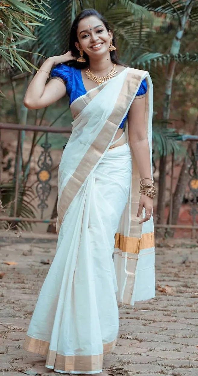woman in a Kerala saree standing near the tree HD wallpaper