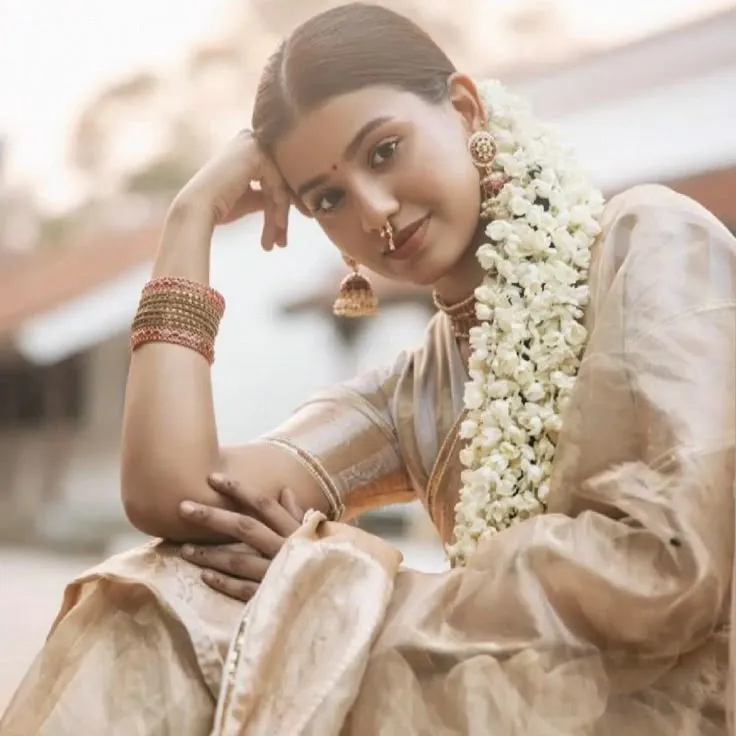 Woman in a Kerala saree with a flower in her hair wallpaper