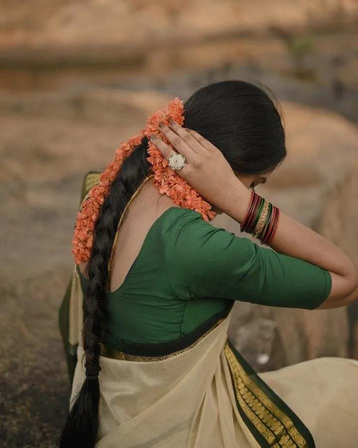 Woman in a saree with a green border and a blouse wallpaper