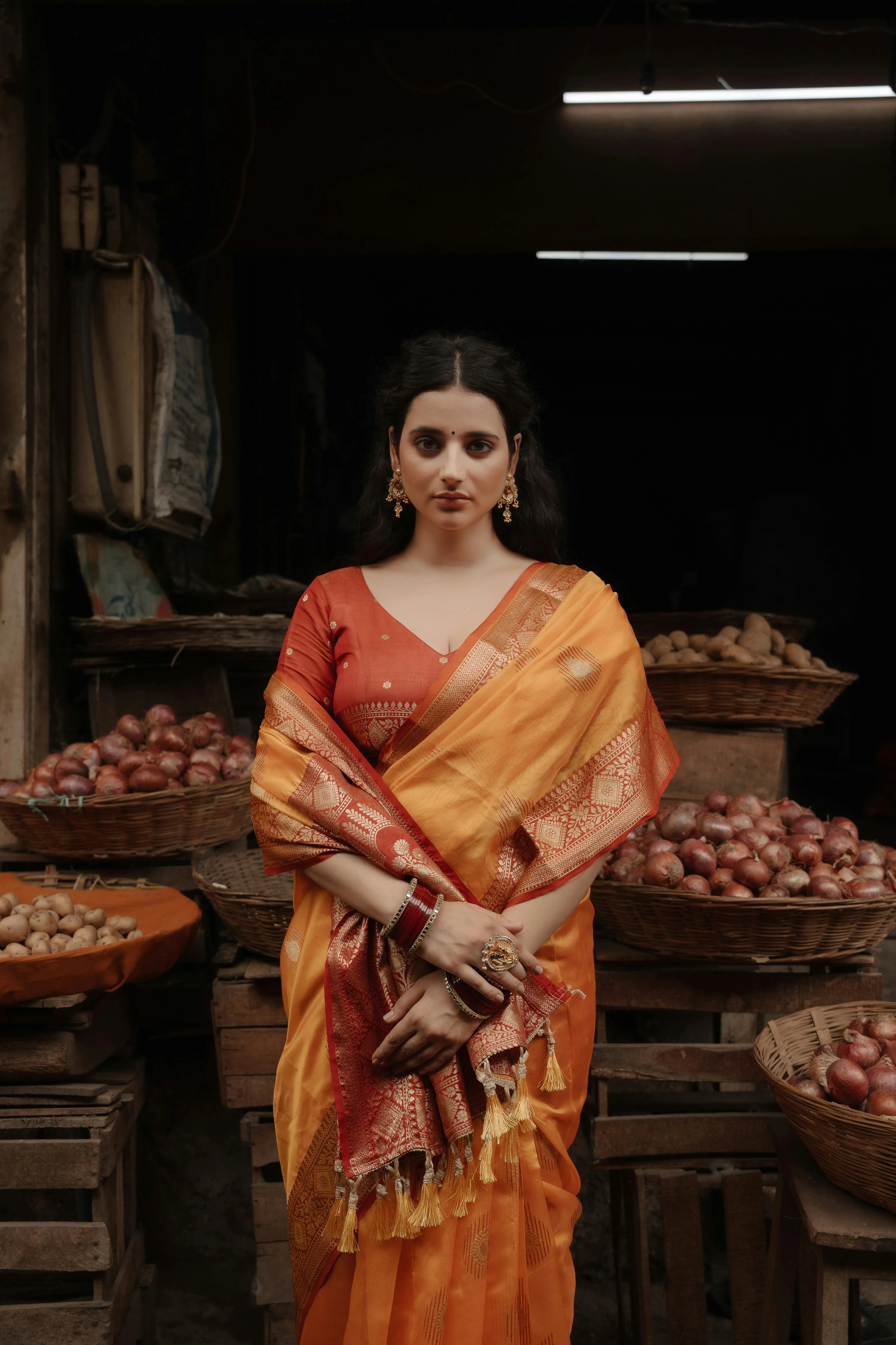 Woman in Beige Saree Sitting Indoors with Calm Elegance