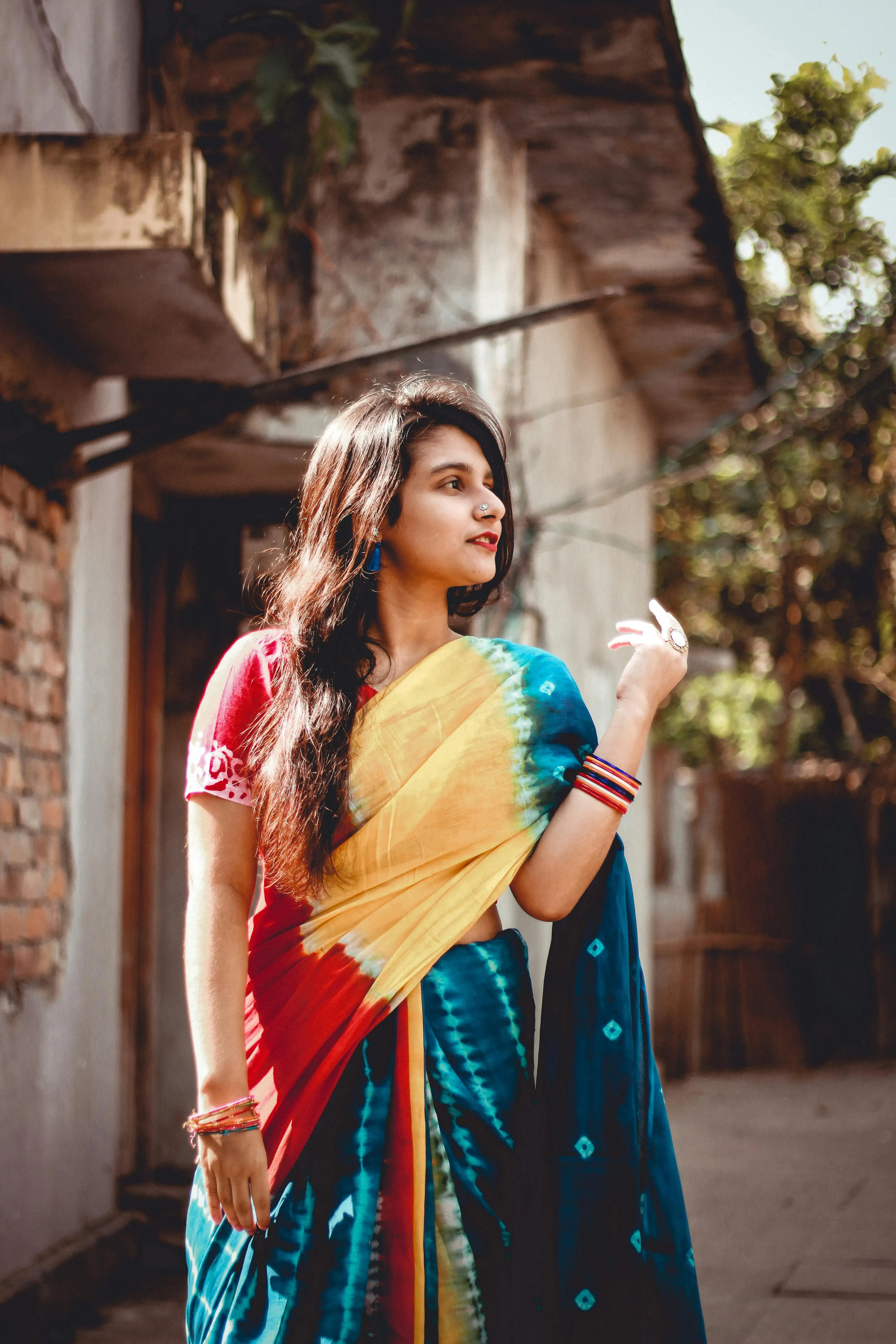 Woman in Blue Saree Smiling Outdoors with Traditional Look