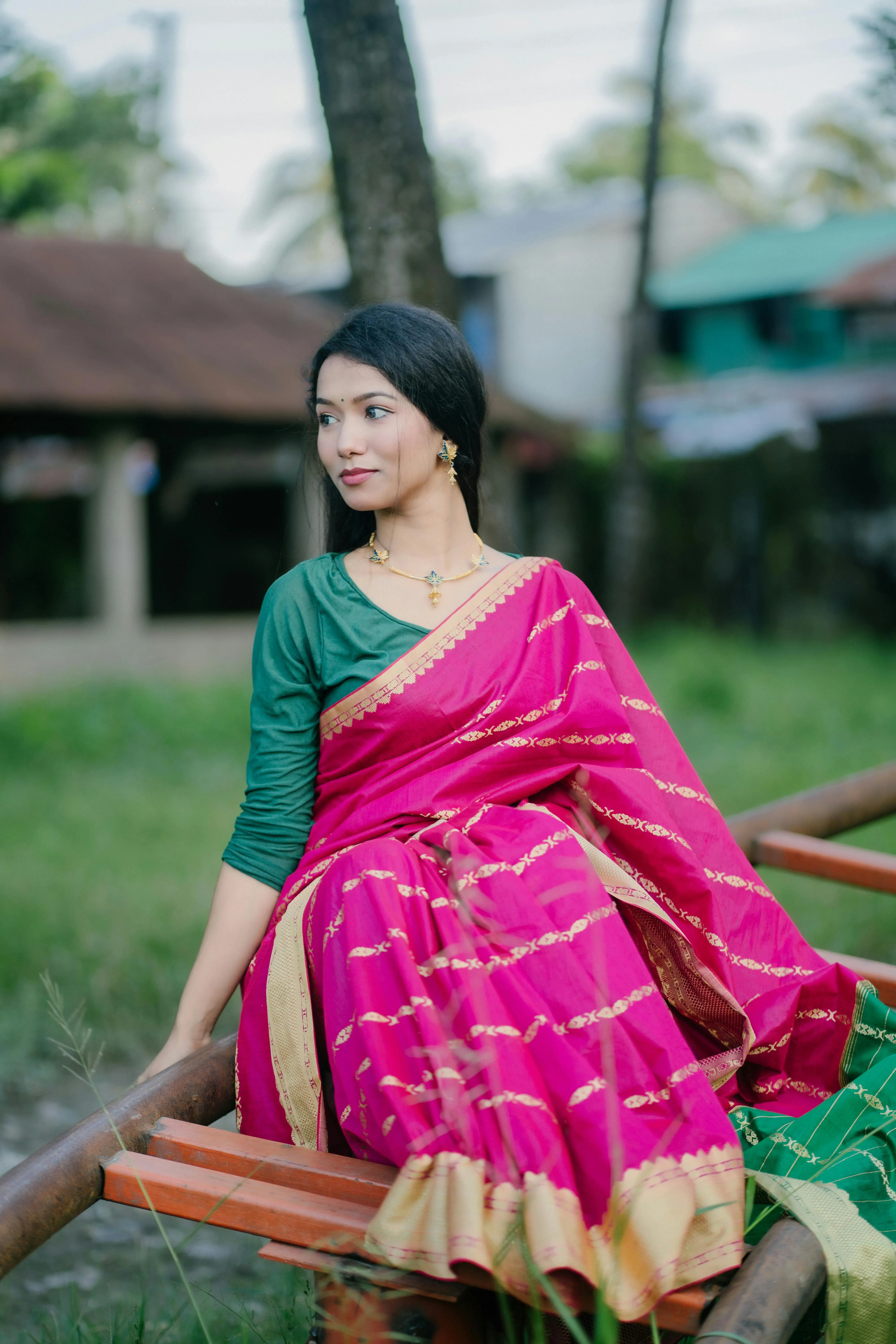 Woman in Pink Saree Posing Outdoors with Modern Elegance