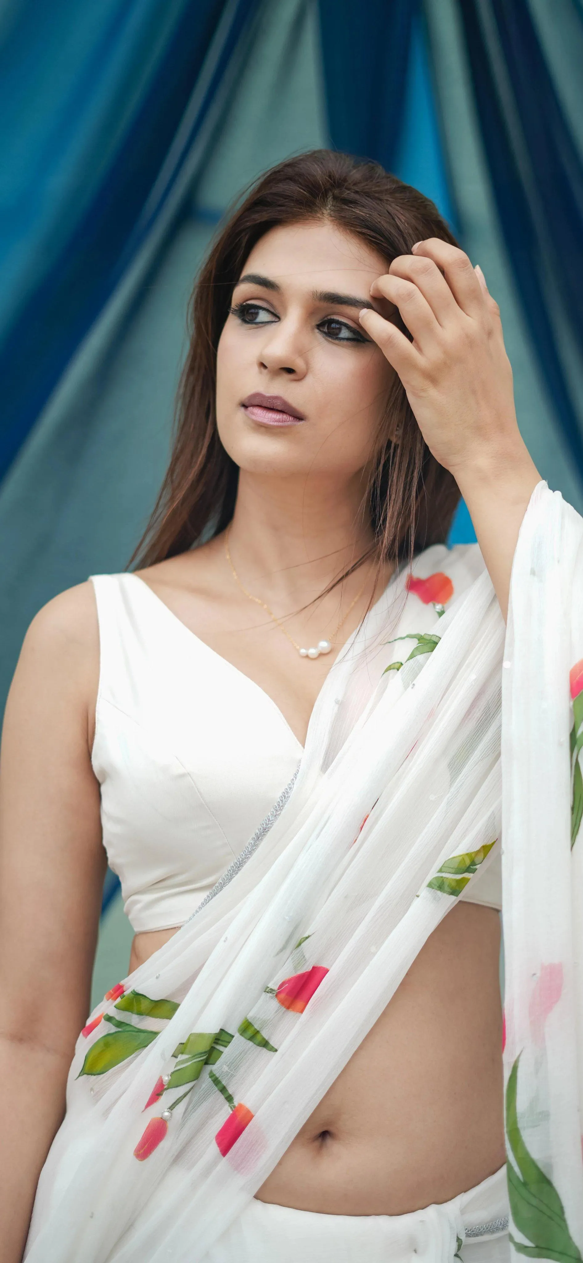 Woman in White Floral Saree Posing with Natural Beauty Image