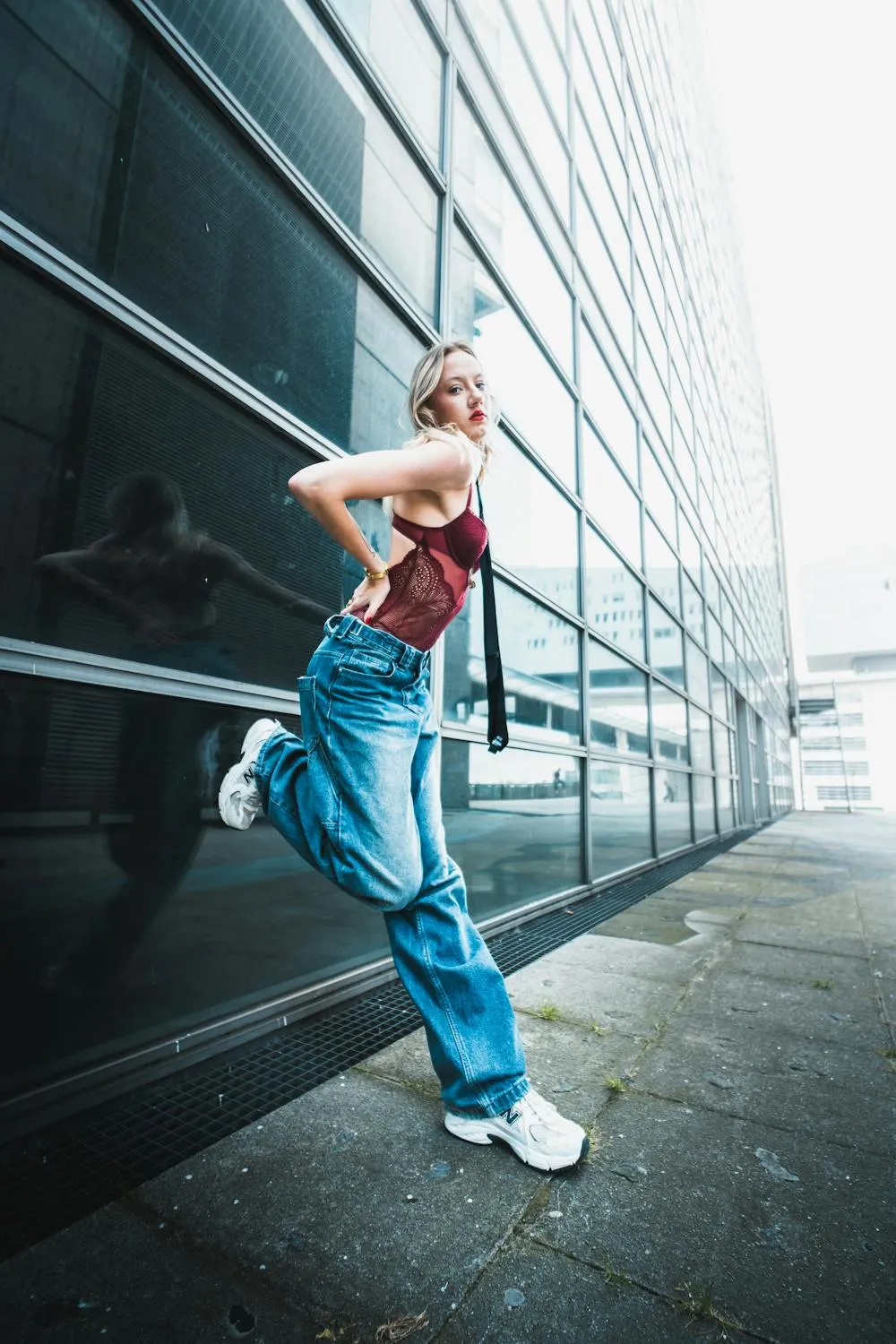 Woman with Jeans and a Red Top Walking in an Urban Area
