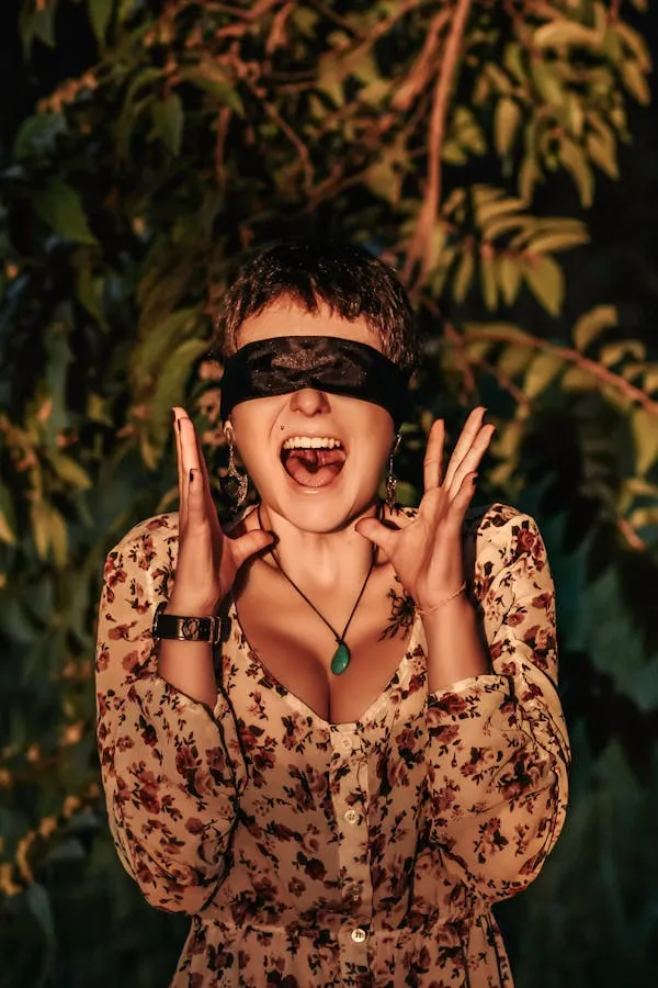 Woman Laughing with Blindfold in a Floral Dress and Beads